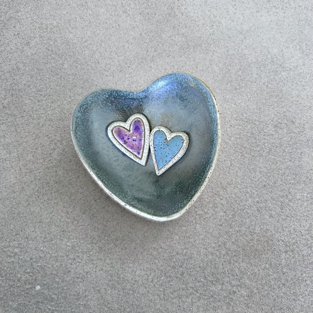 Heart-shaped ceramic dish with two colorful hearts