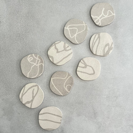 set of neutral ceramic coasters