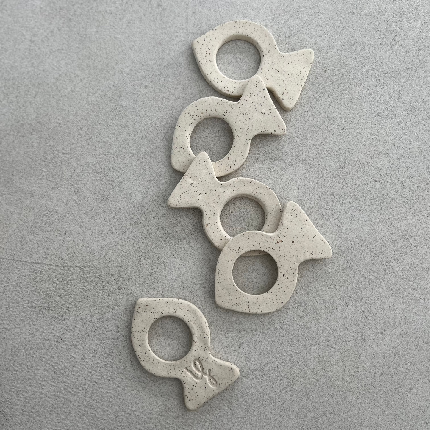 four fish-shaped ceramic napkin rings